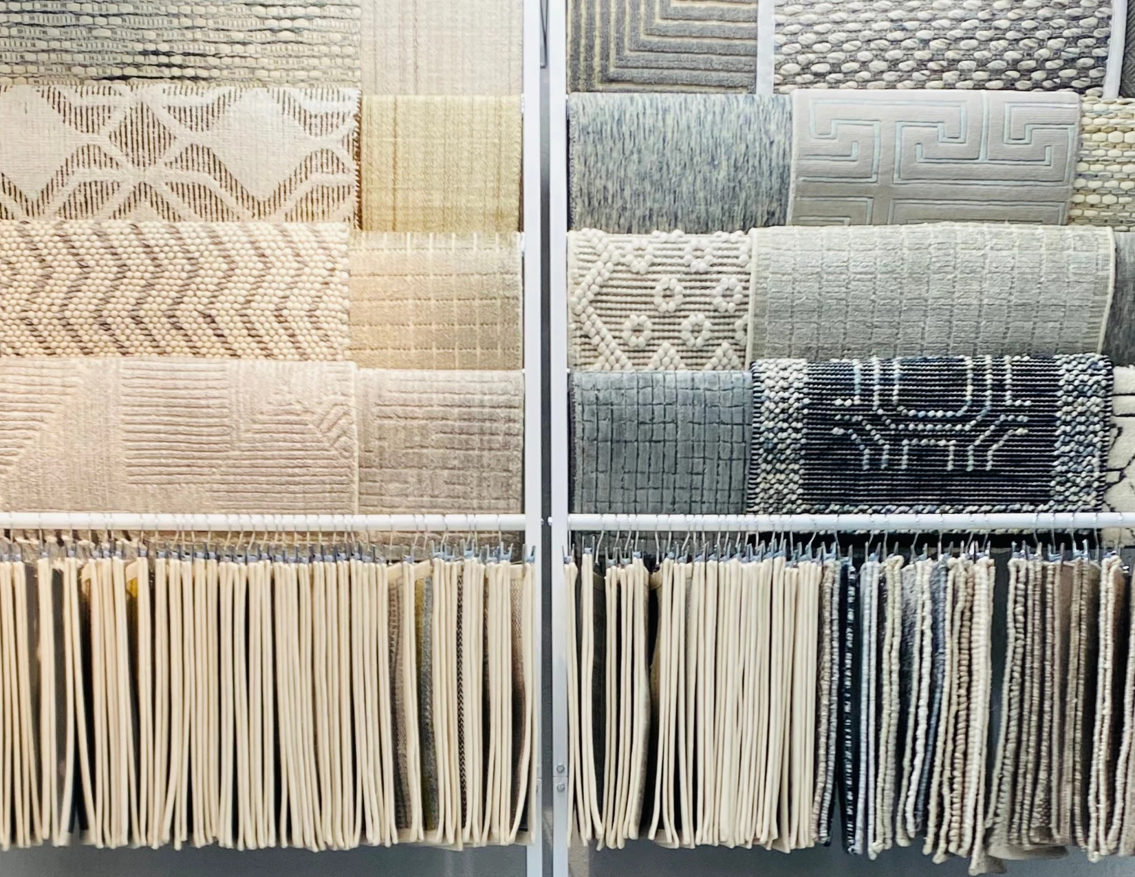 Luxury carpet samples in ivory, gray and charcoal displayed in the showroom